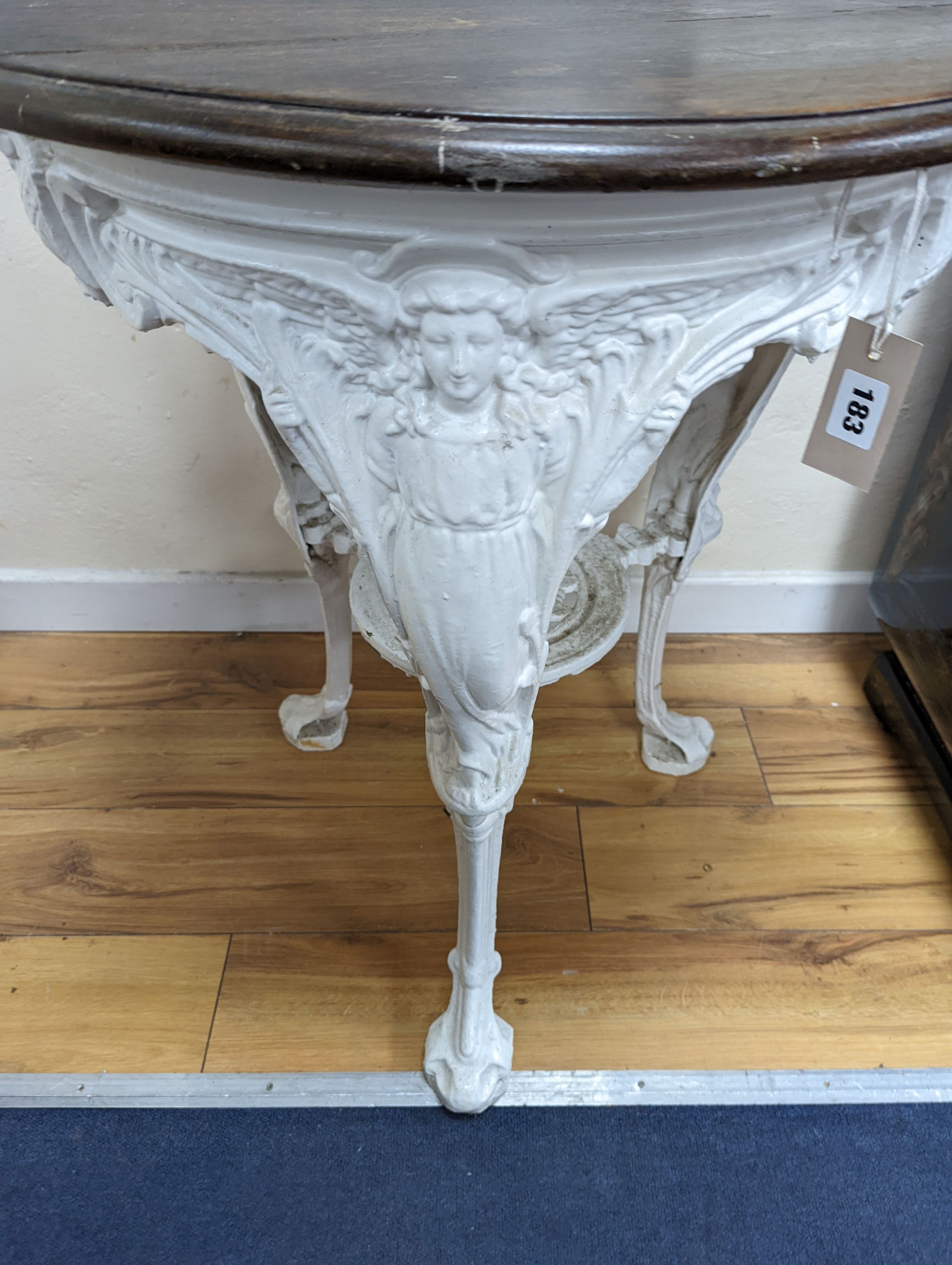 A Victorian white painted cast iron Britannia pub table, diameter 62cm, height 77cm